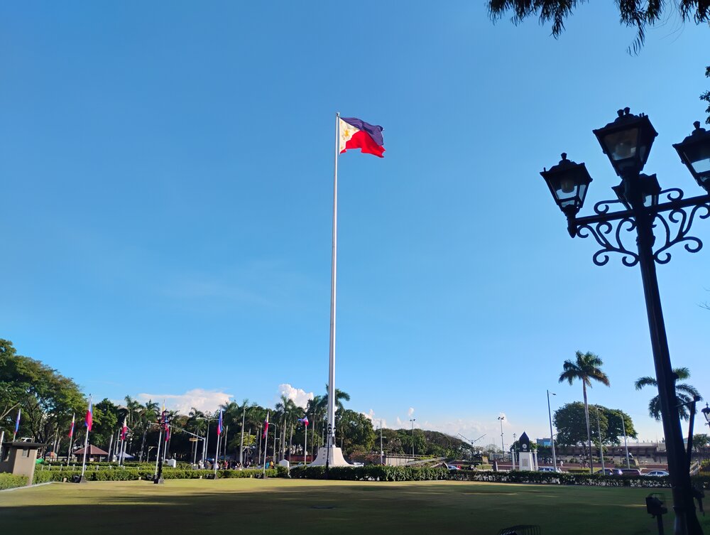 The Rizal Monument in Manila with the Philippine flag flying